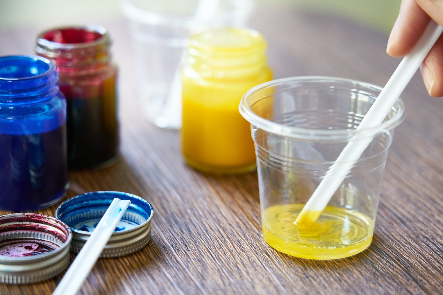 Mixing yellow resin chemical in plastic cup